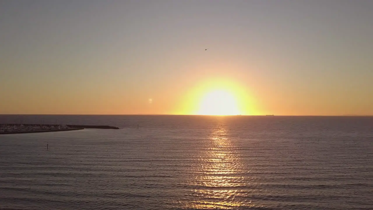 Helicopter flying over sea sunsetting Hampton bay Australia Melbourne Pan left to right