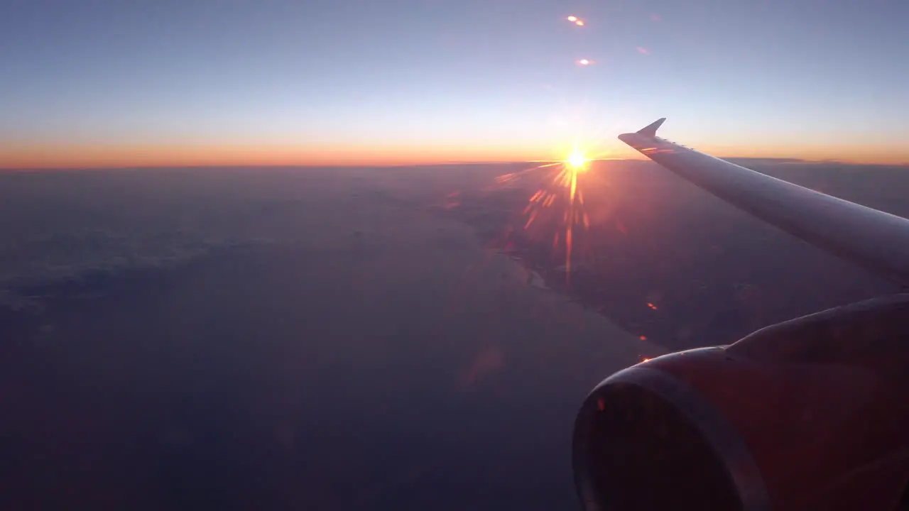 Sun rise or sun set over coast line from the airplane