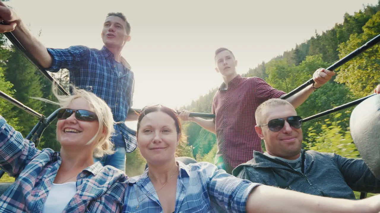 A Cheerful Family With Children Is Riding In The Back Of A Jeep Safari In The Forest And Mountains A