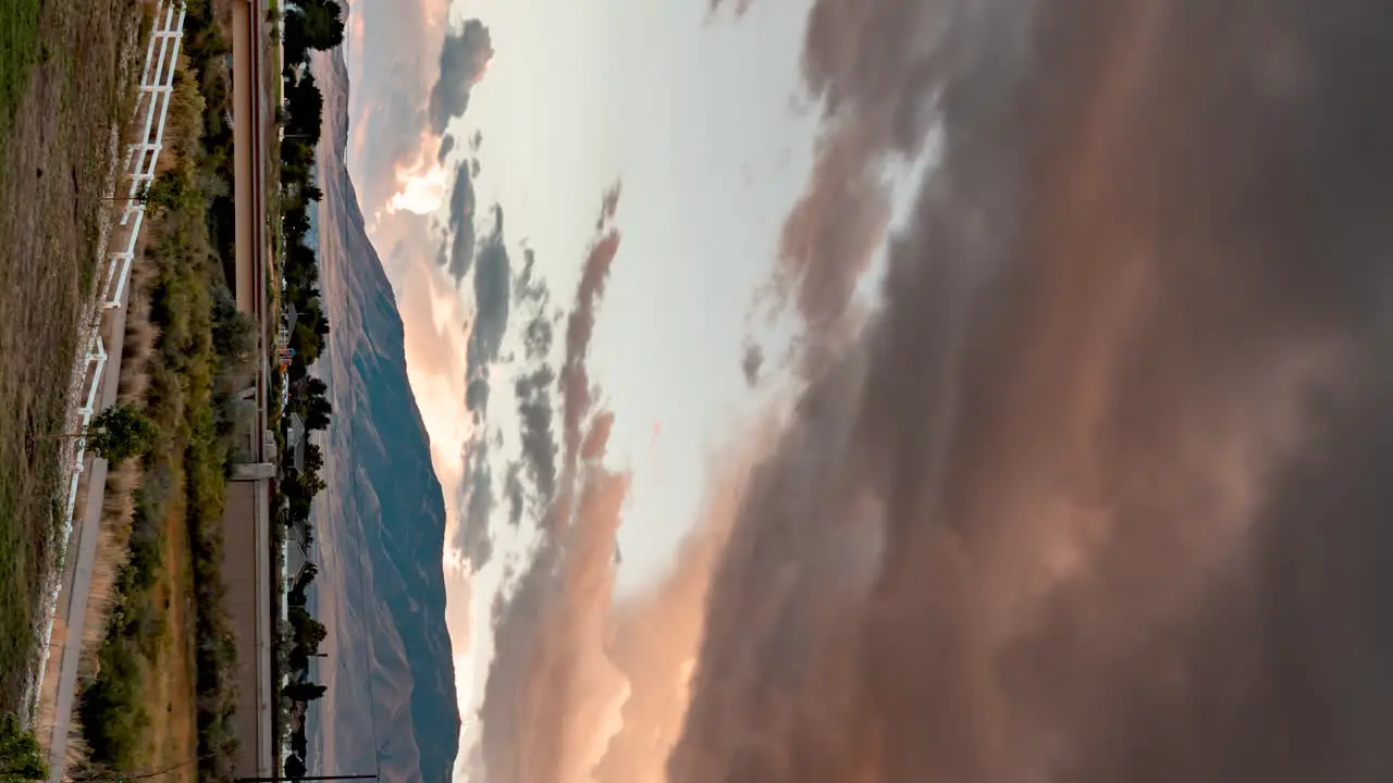 Panoramic time lapse of stormy clouds at sunset over a mountain landscape vertical orientation