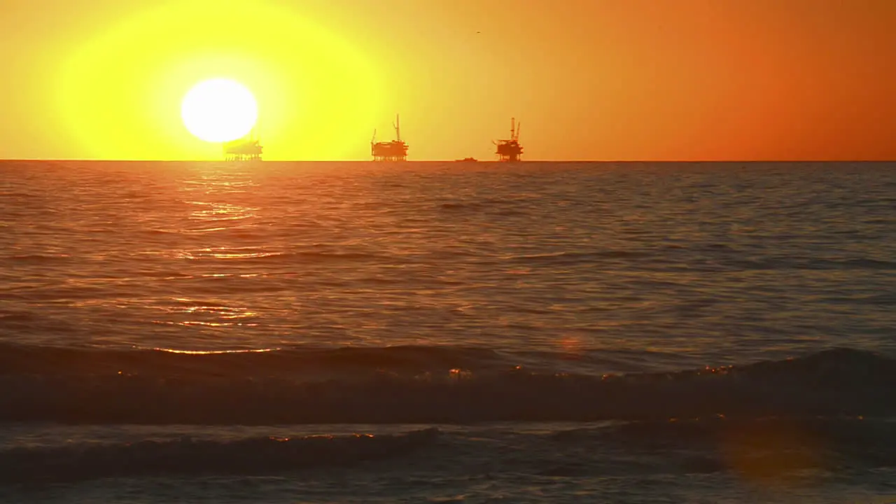 Winter sunset over the Pacific Ocean behind three oil platforms off of the Carpinteria coast near Santa Barbara California