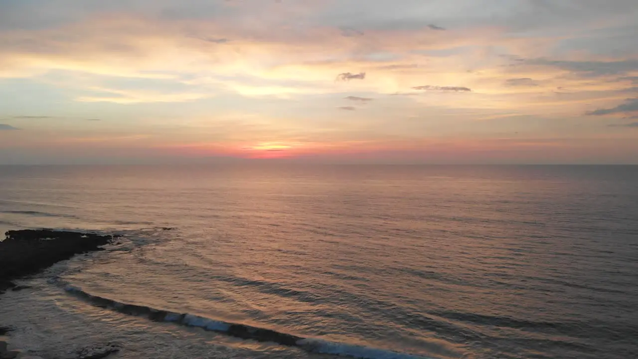 Ascending aerial of sunset over sea in La Union Philippines