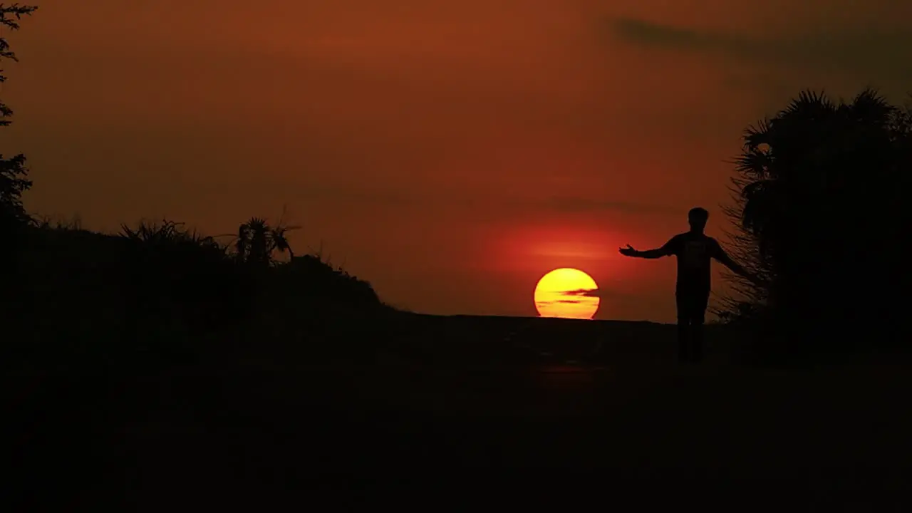 Man walking alone through the Diu city road of India against sun