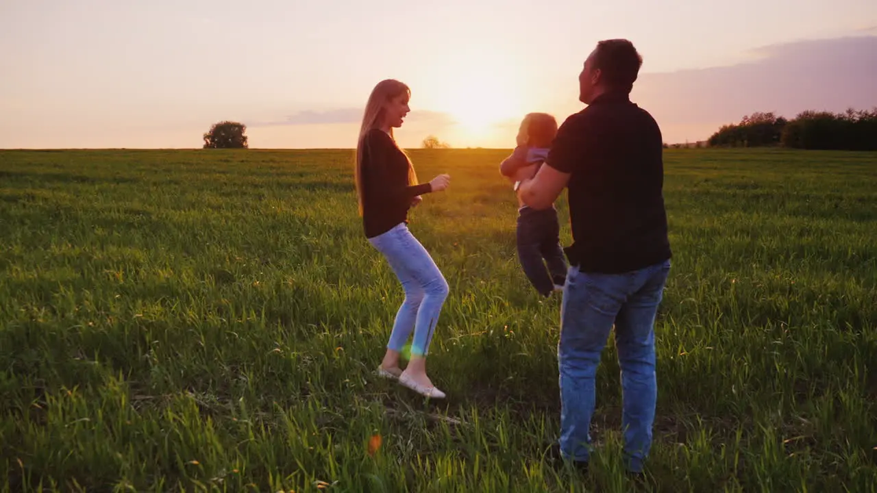 A Young Couple Is Having Fun With Their Young Child In A Picturesque Place