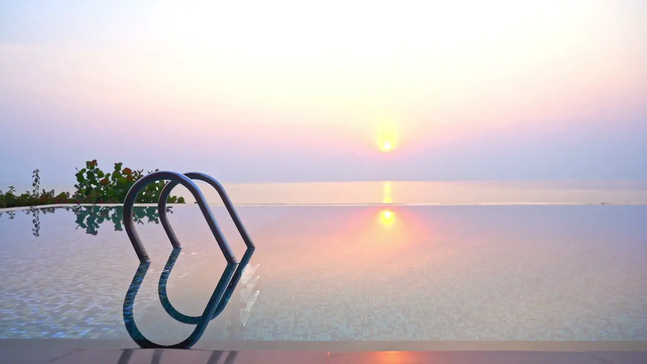 Empty Outdoor Infinity Pool with Panoramic Sea View at Sunrise