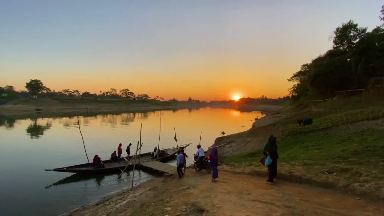 Rural river crossing scenery with boat wharf during sunset