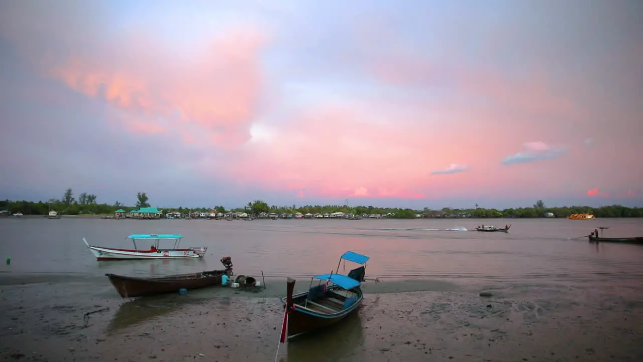 A Beautiful View Overlooking Pak Nam River in Krabi Thailand with a Pink Cloudy Sunset and Longtail Boats