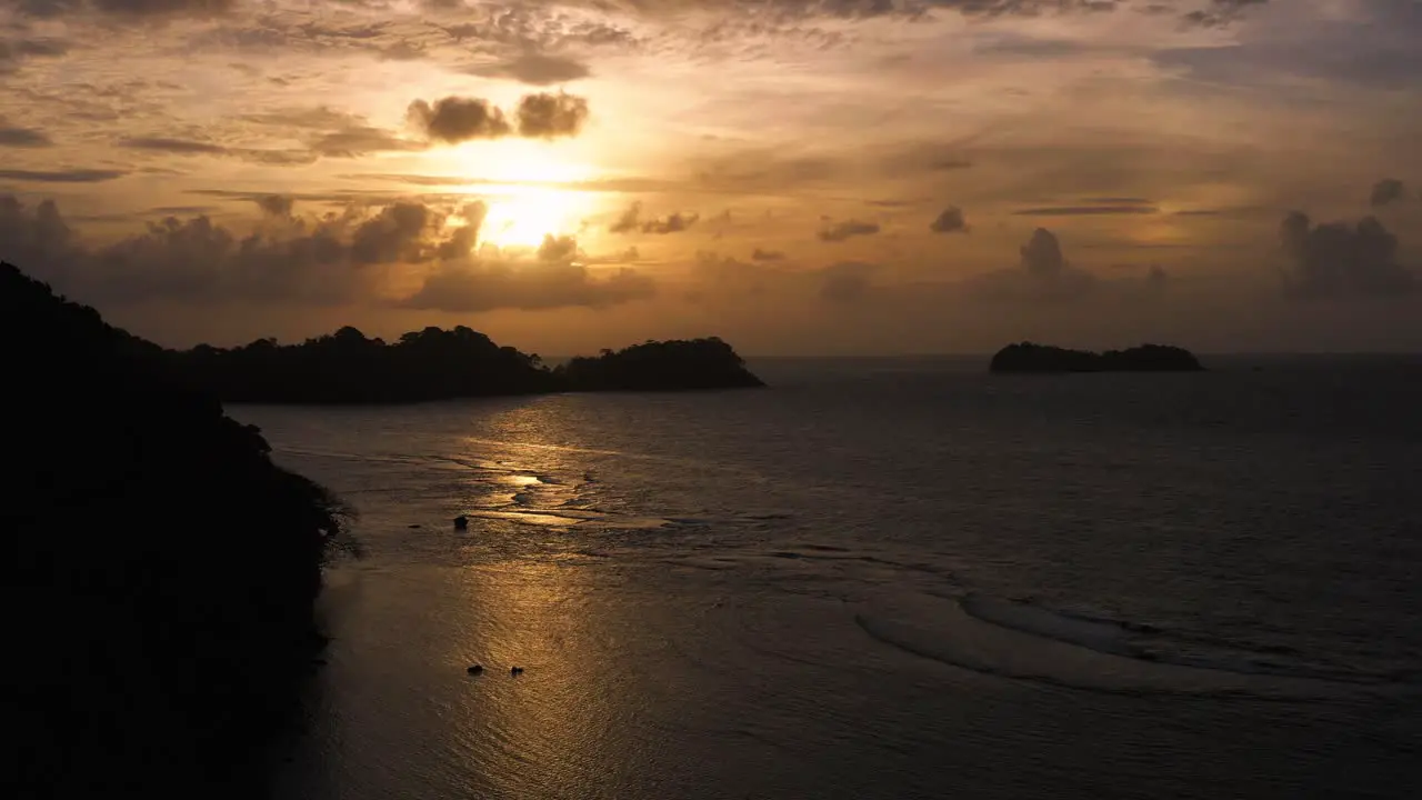 Atmospheric golden silhouette orange Panama coastal aerial view above ocean seascape at sunset