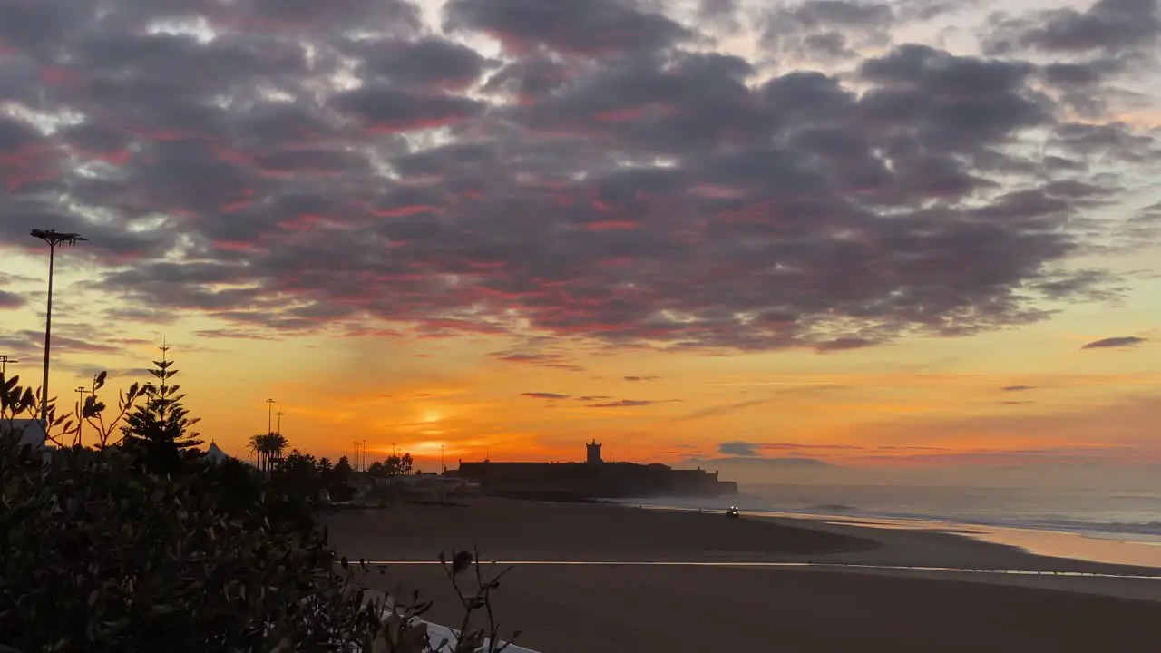 Beautiful scenic sunset with rays of sun shining through clouds over beach