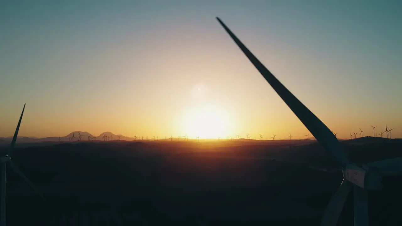 Aerial View Silhouette of Wind Turbine Blades Spinning