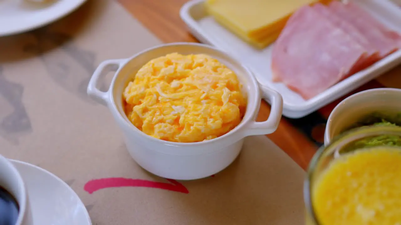 freshly prepared scrambled eggs in a white ceramic pot