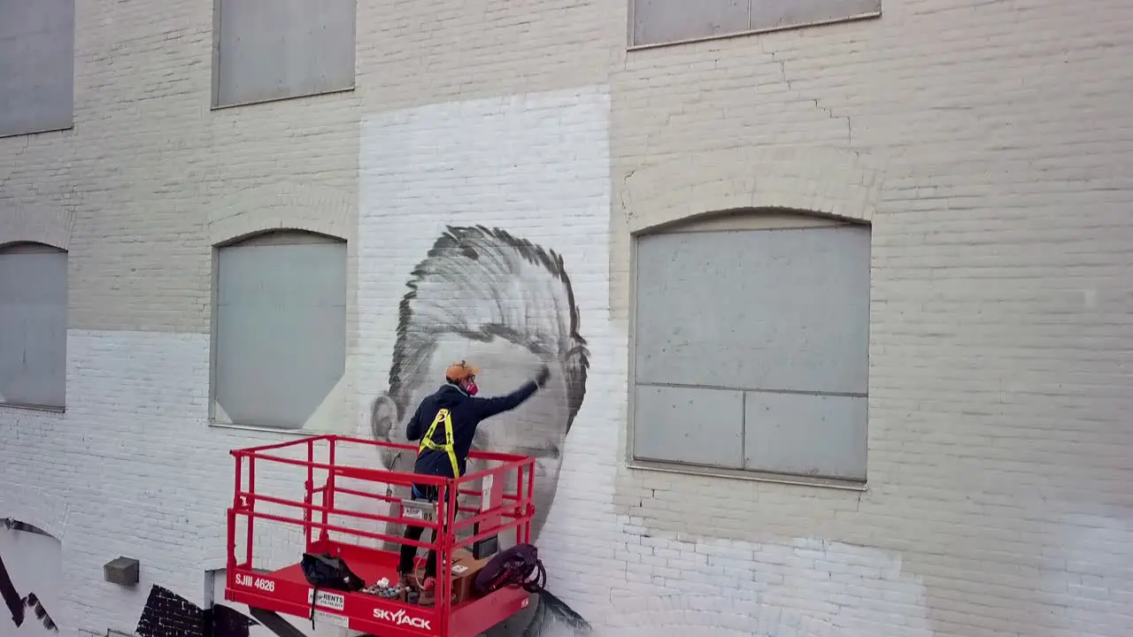 Graffiti Painter Creating Portrait on Wall of Building Drone Pedestal