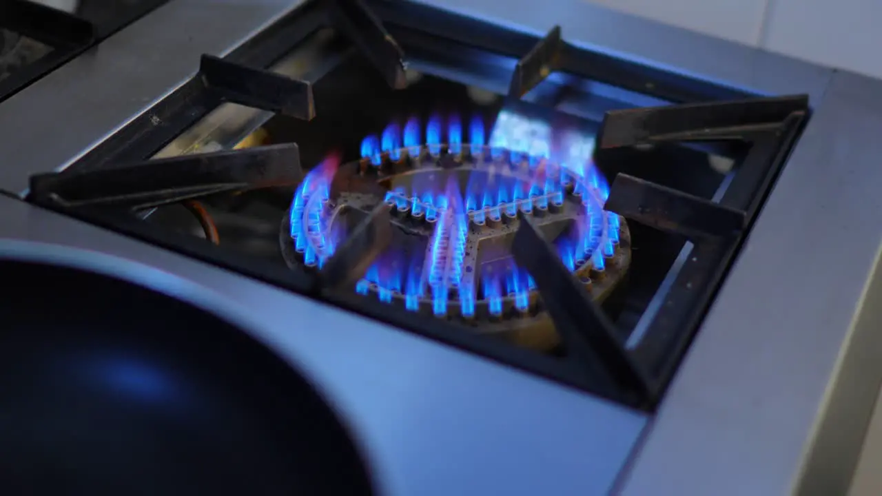 stove lit to the maximum with blue flames