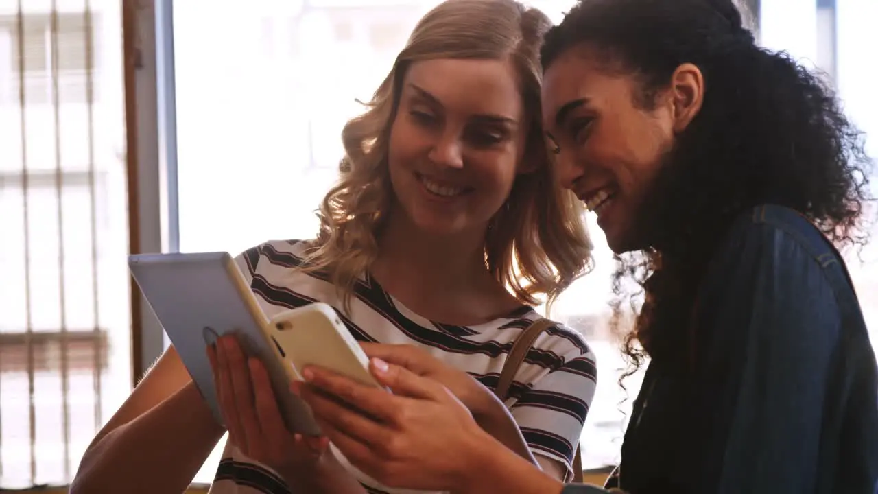 Handsome women using mobile phone and digital tablet