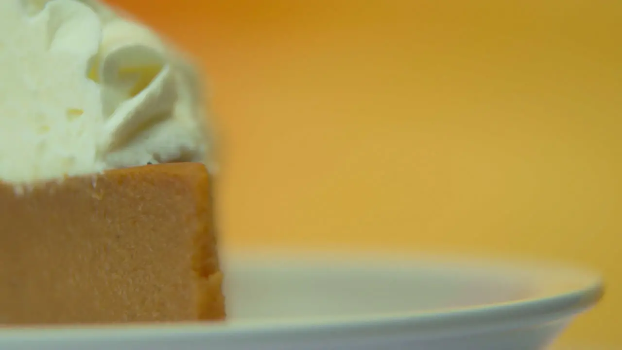 [Camera Used Canon C300] Macro shot rotating pumpkin pie slice loaded with fluffy whipped cream