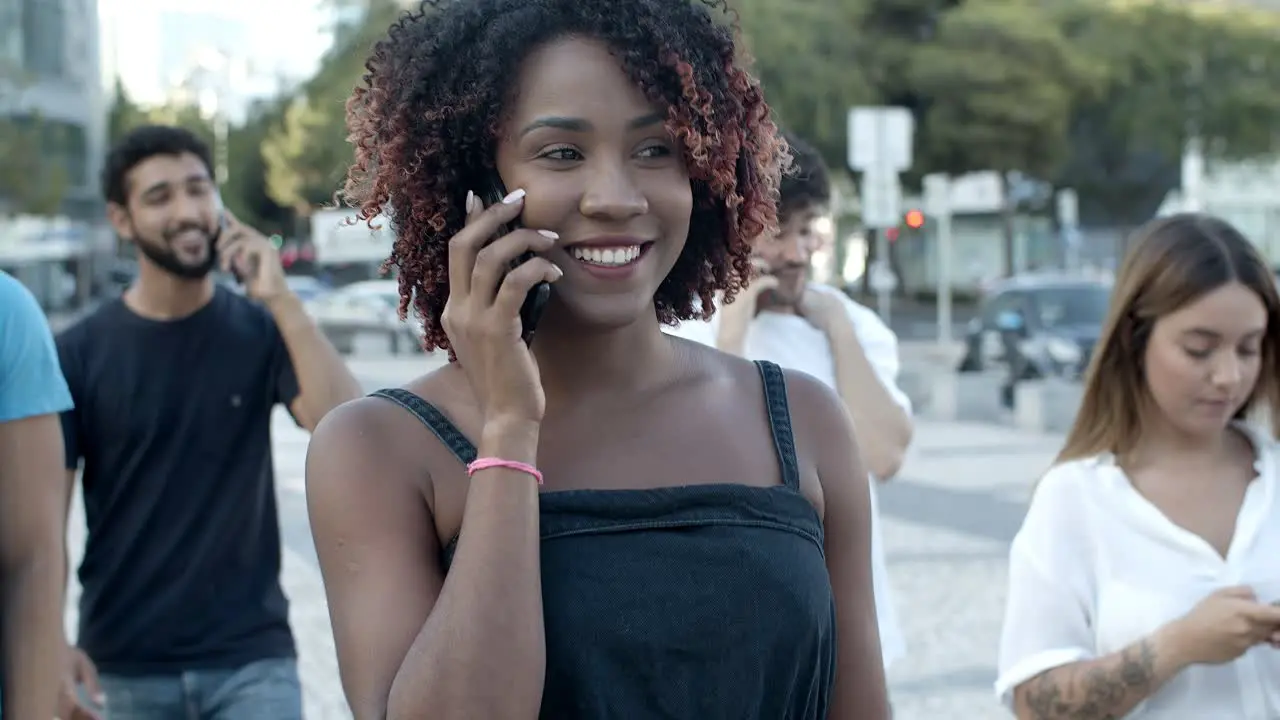 Smiling young woman talking on smartphone