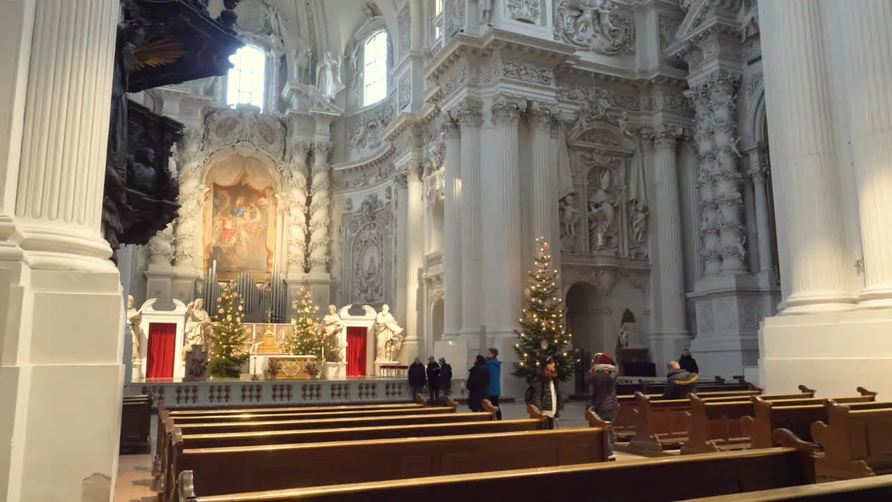 Multiple people walking around the Theatine Church in Munich