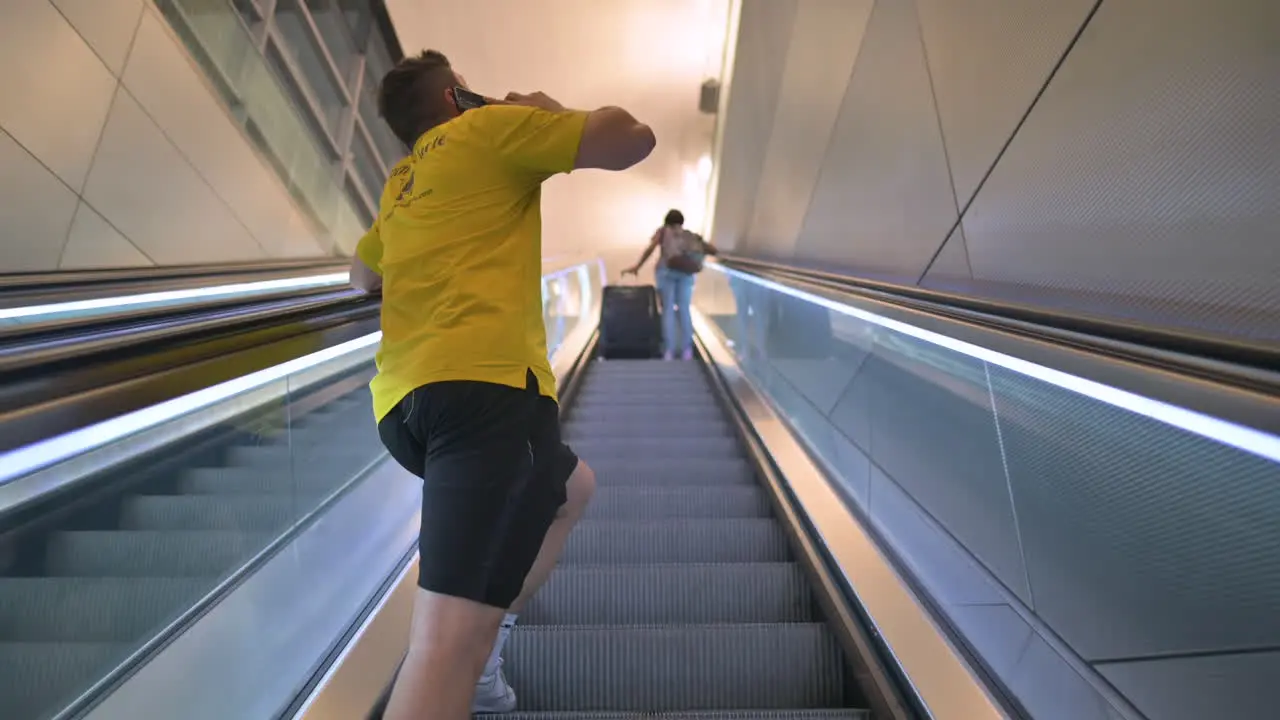 People going up on escalator at airport