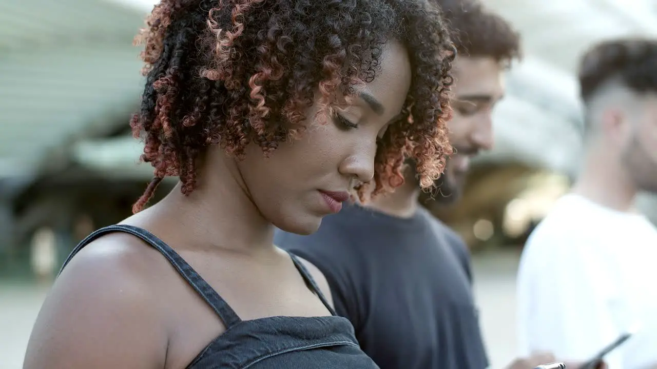 Cheerful young lady texting with smartphone