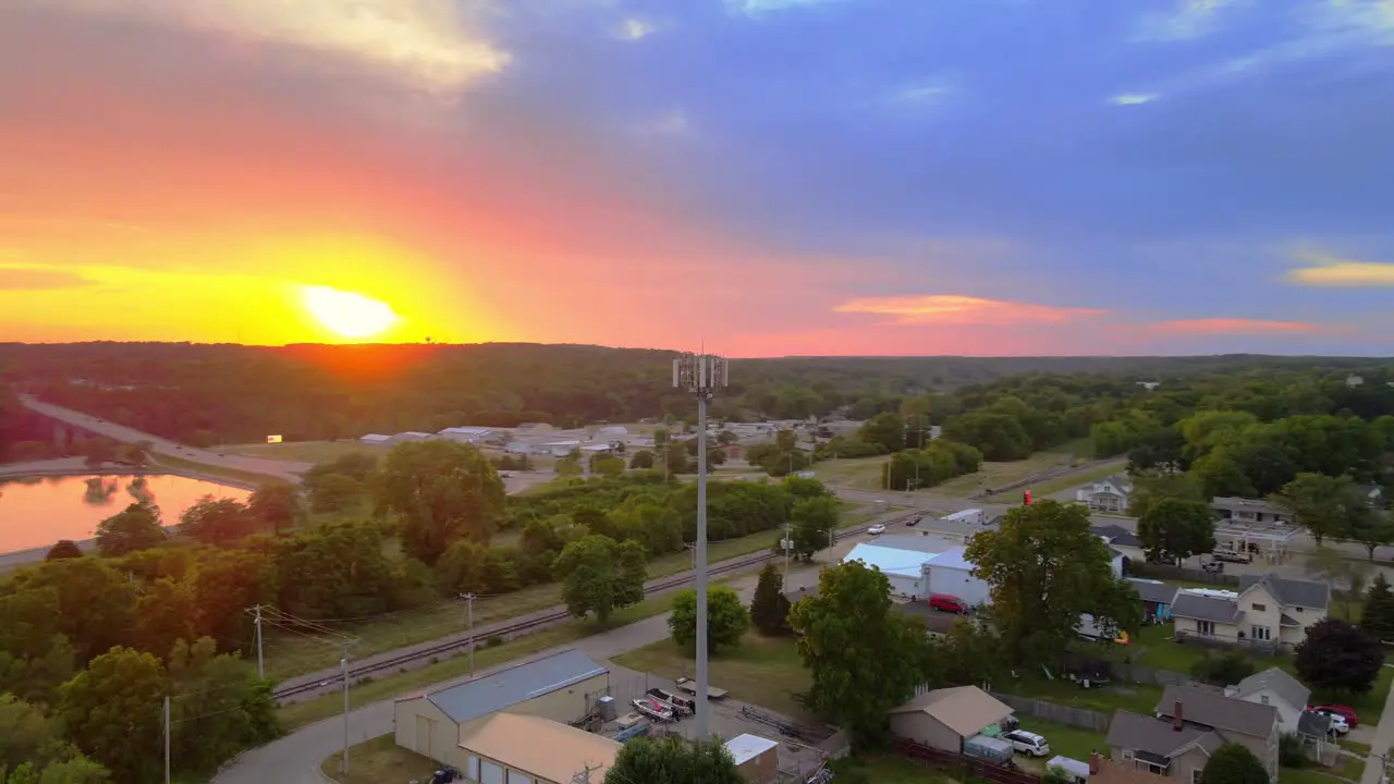 Cell Tower Under Colorful Sunset Sky Over Village In Janesville Wisconsin