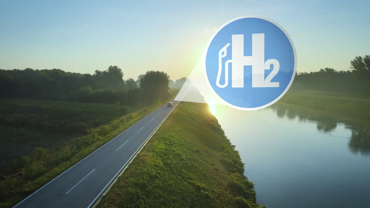 Hydrogen powered car drives into the sunset on an idyllic road at edge of river