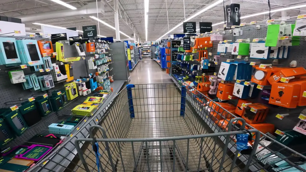 POV while pushing a cart through Walmart in electronics section specifically cell phones and cables