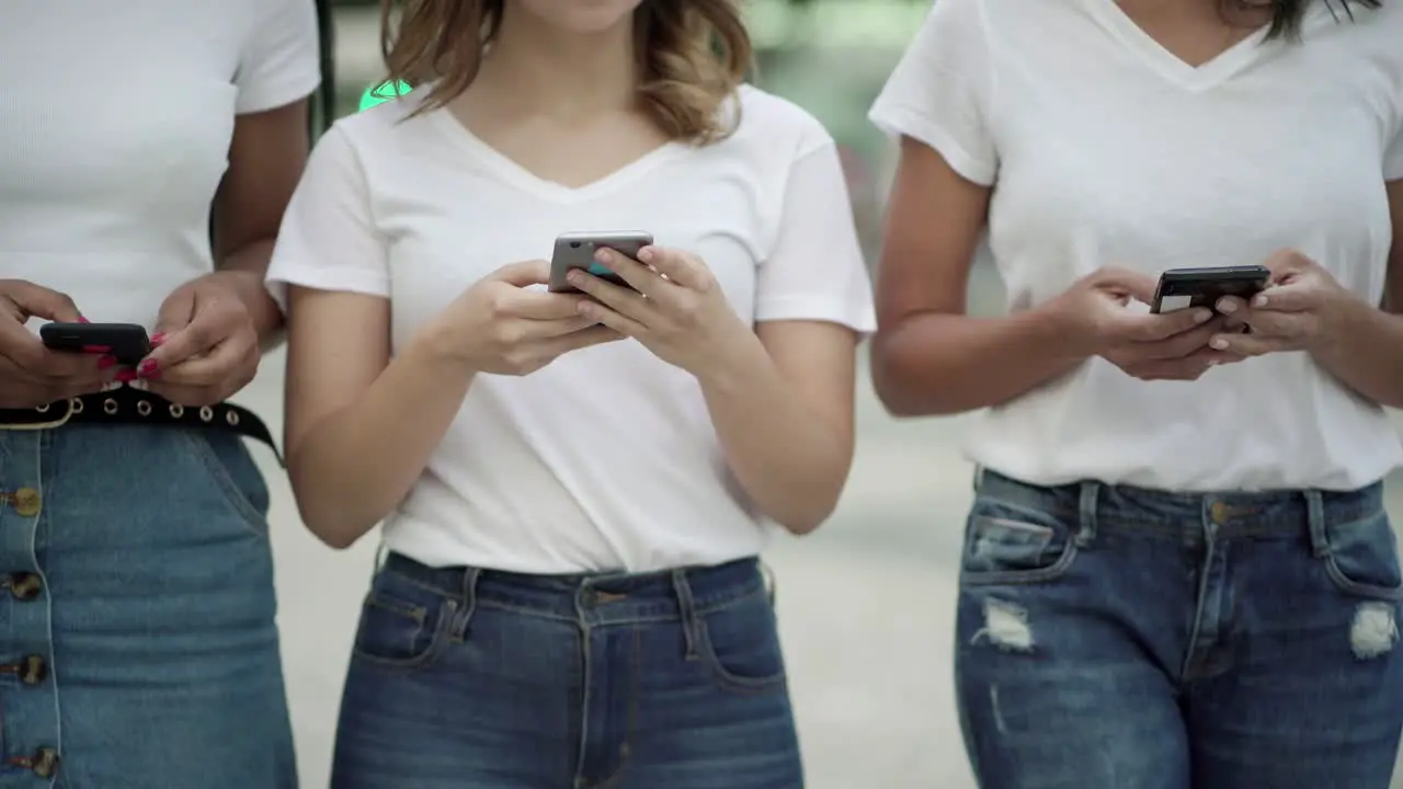 Cropped shot of friends holding modern phones