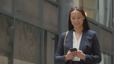 Businesswoman Outside City Of London Offices Using Mobile Phone 1