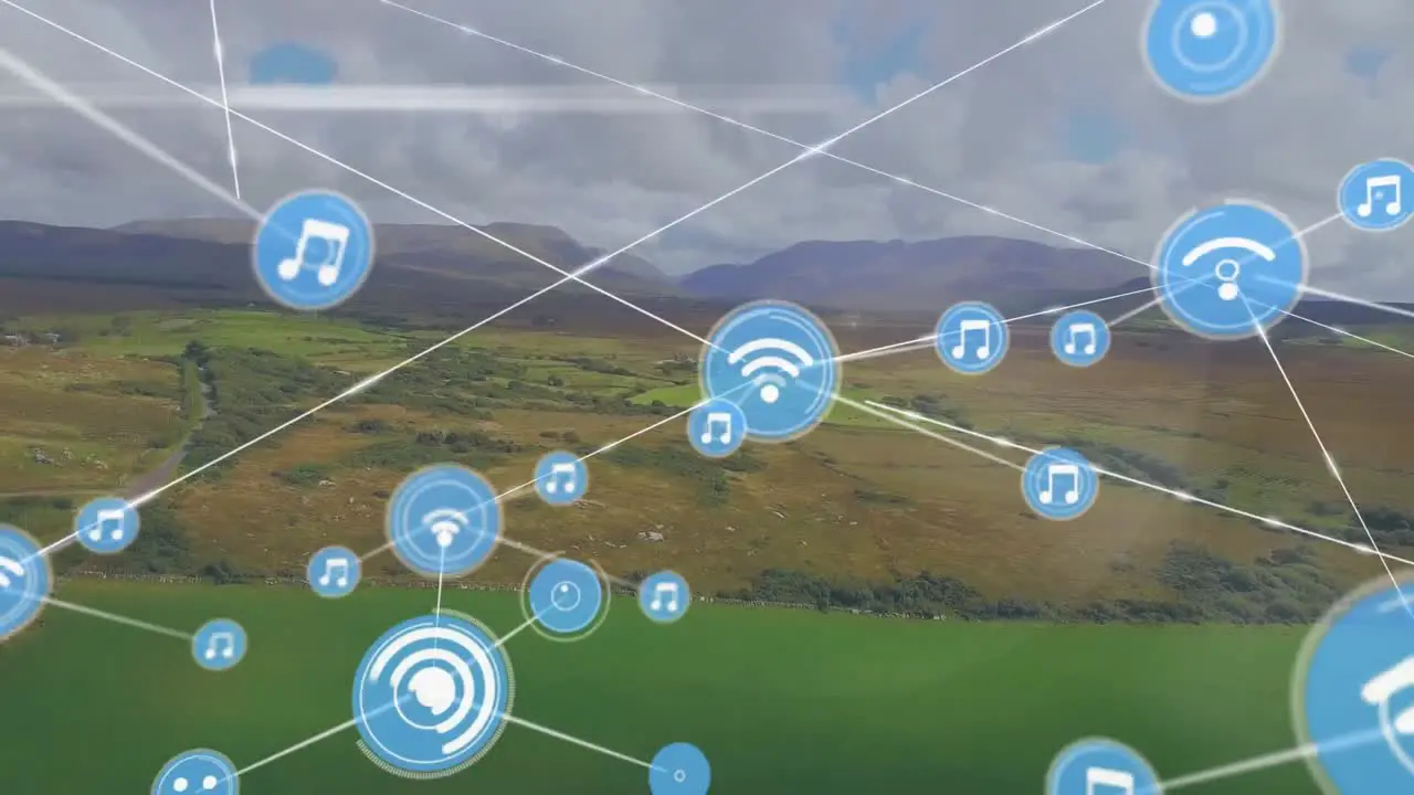 Animation of icons connected with lines aerial view of green field against mountain and cloudy sky