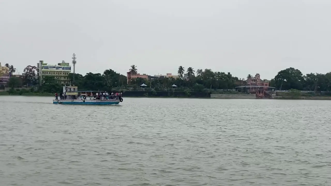 Kolkata India  Shot of a ferry boat moving over river Ganga on a cloudy day