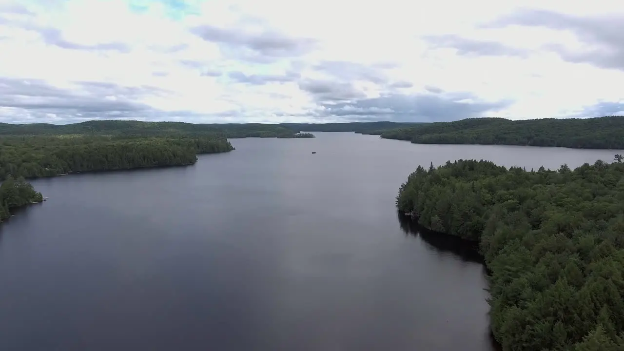 Wide Angle of Drone Flying Up Over a Lake in the Summer