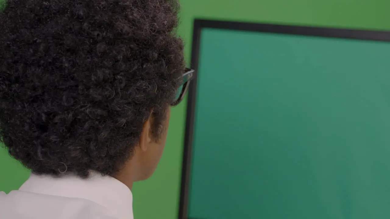 CU Businessman Looking at Computer on Green Screen