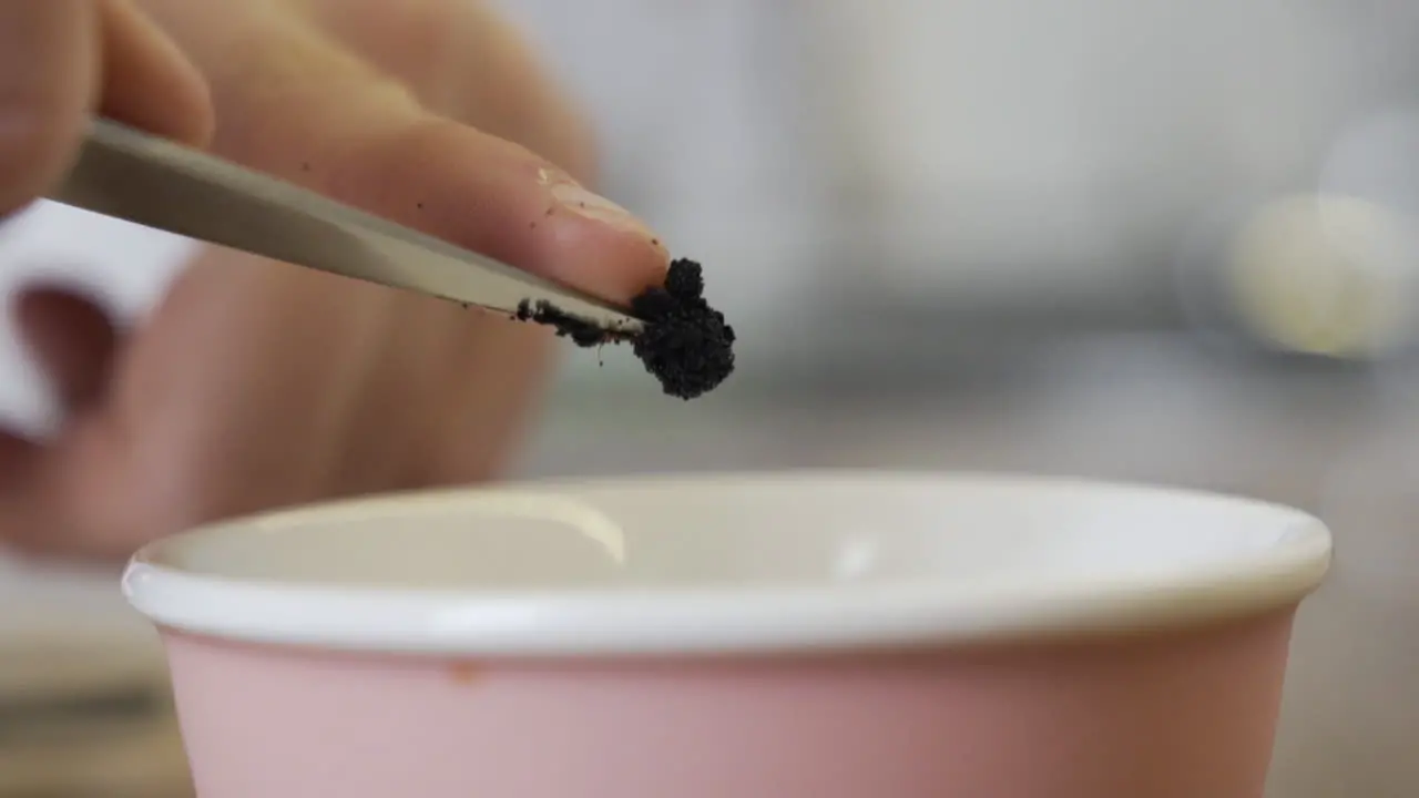 Taking raw vanilla in a bowl with a finger from the tip of a knife