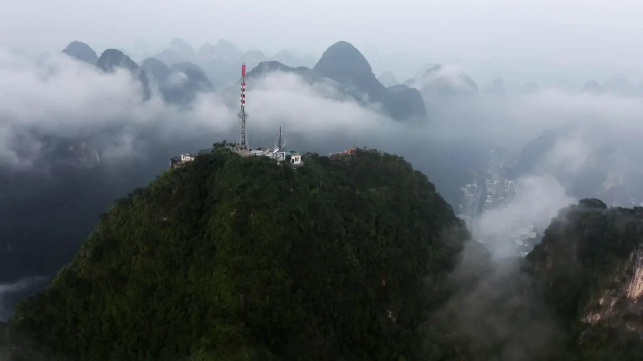 Yangshuo mountains 4k drone circling around Tv Tower radio communication tower