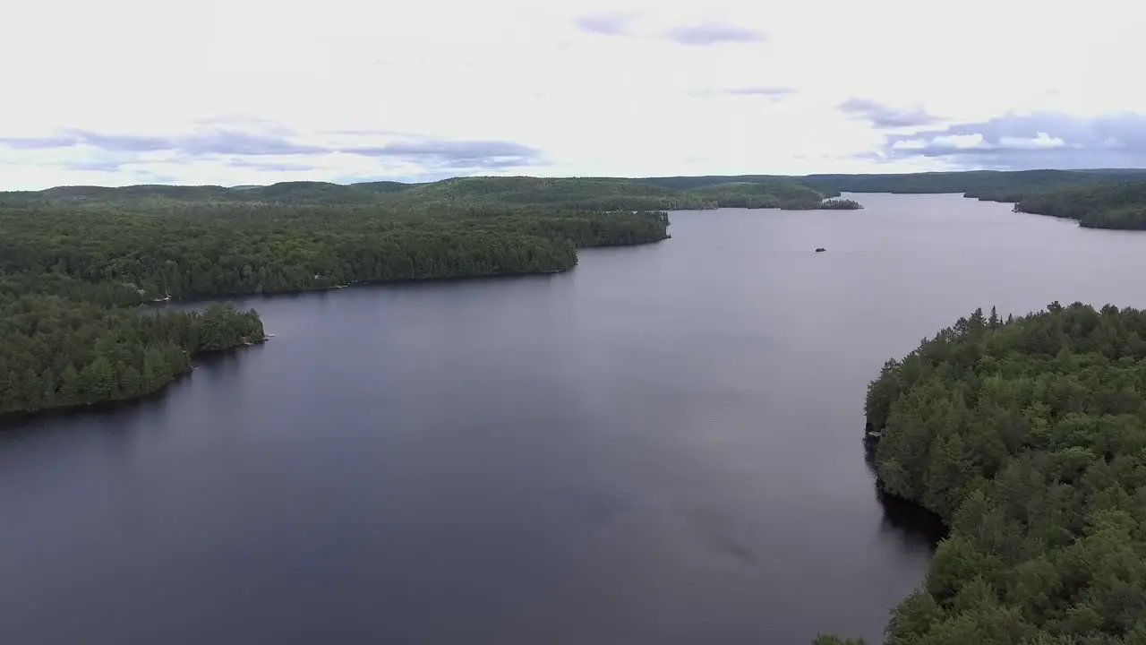 Wide Angle of Drone Flying Forward Over a Lake in the Summer