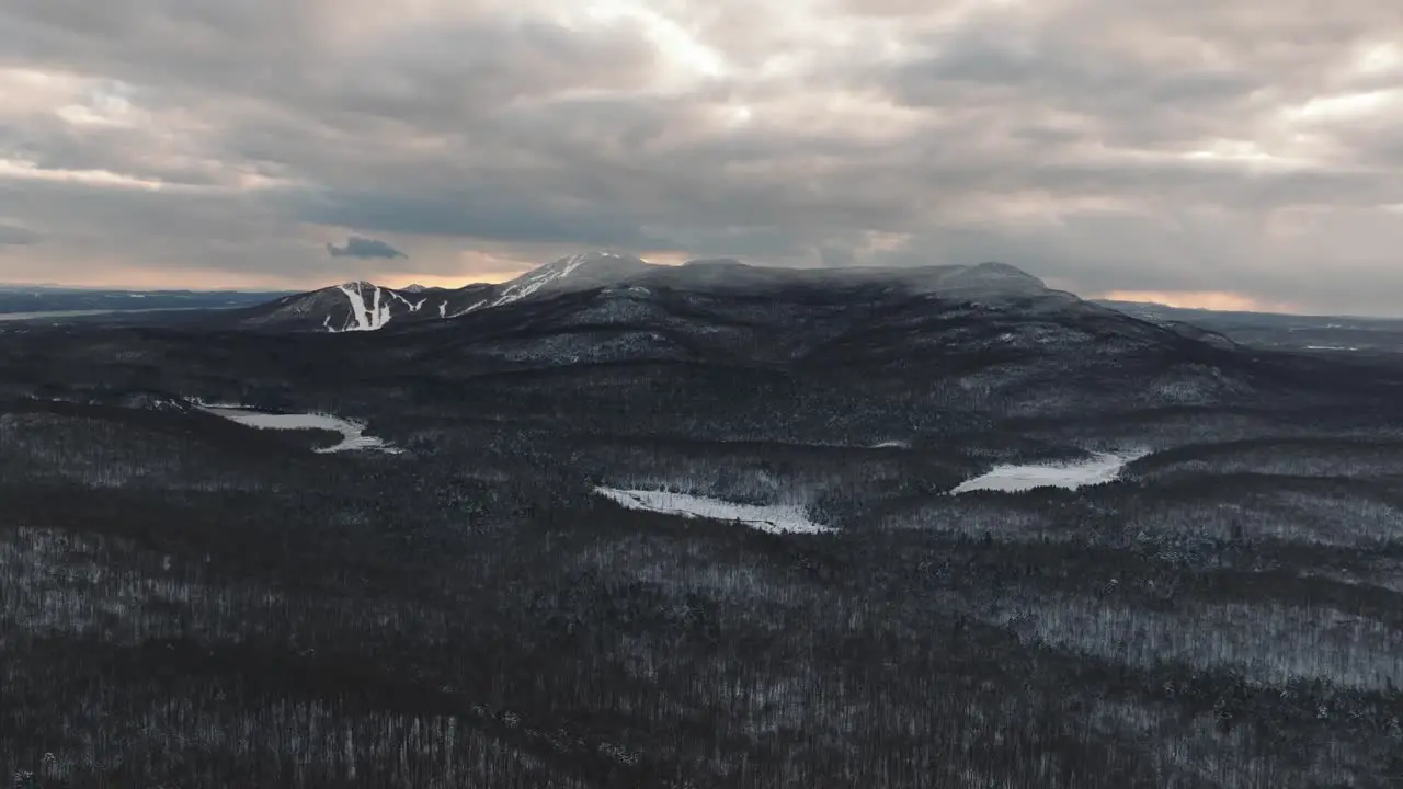 Monochrome Of A Snowy Forest And Mountains Under Clouded Sky In Orford Quebec Canada