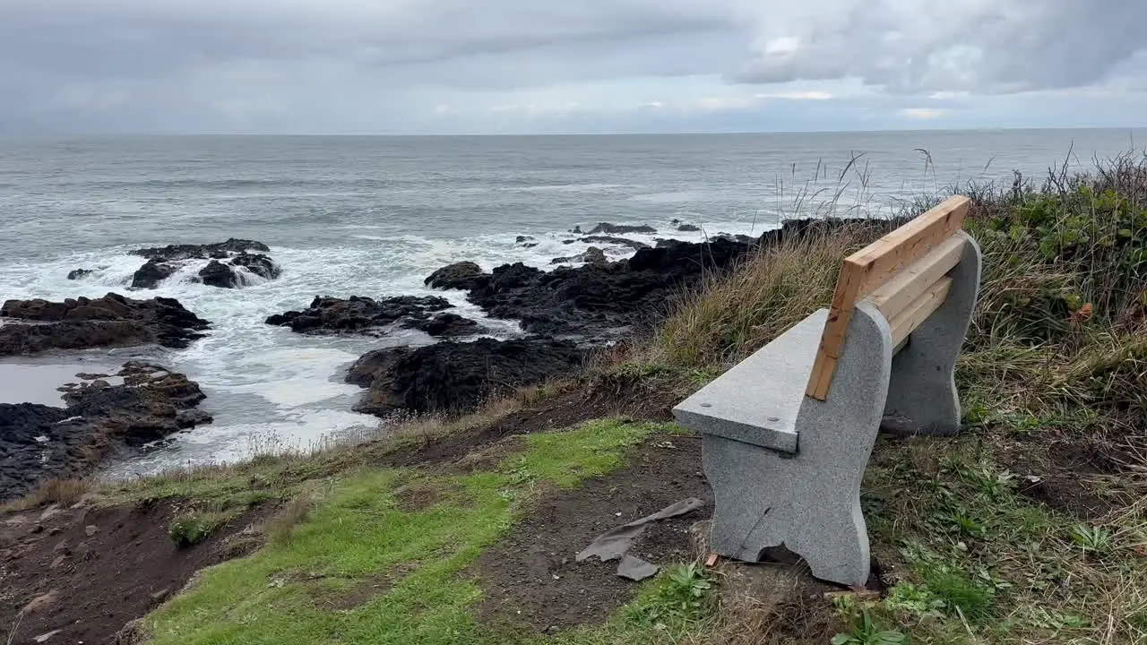 Empty Bench Facing Rocky Beach On A Cloudy Day In Oregon