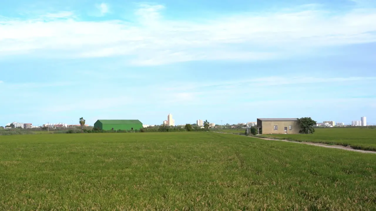 Shot of a path surrounded by green grasslands along the picturesque village with unique natural landscape on a cloudy day