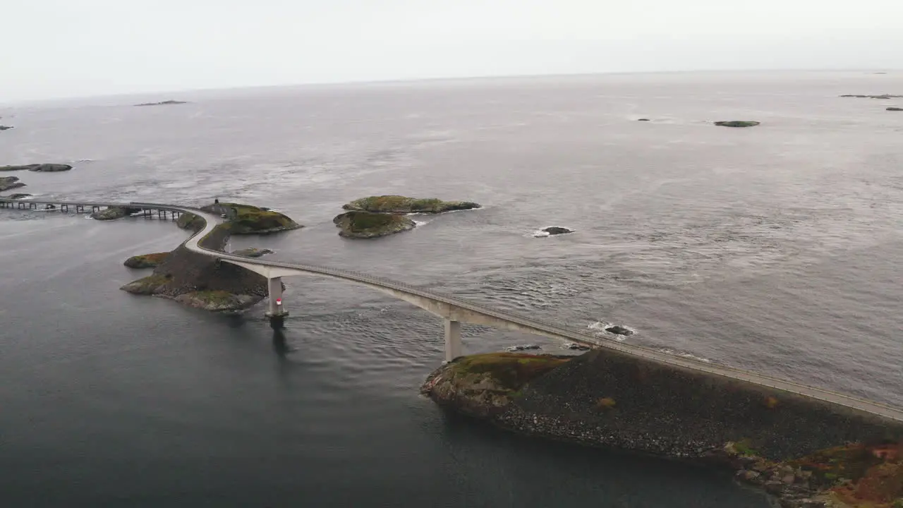 View Of Storseisundet Bridge And Atlantic Ocean Road On A Cloudy Day In Norway drone shot