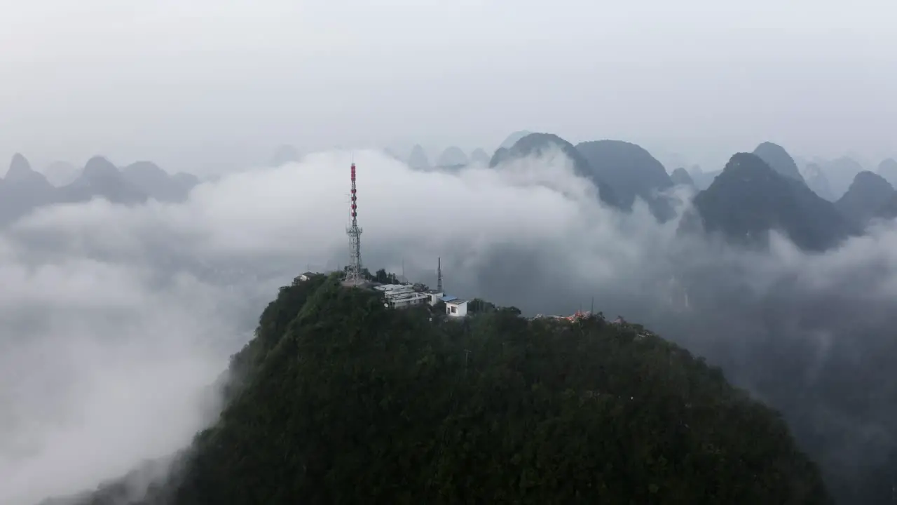 4k drone zoom out mountains around Tv Tower above the misty clouds guilin