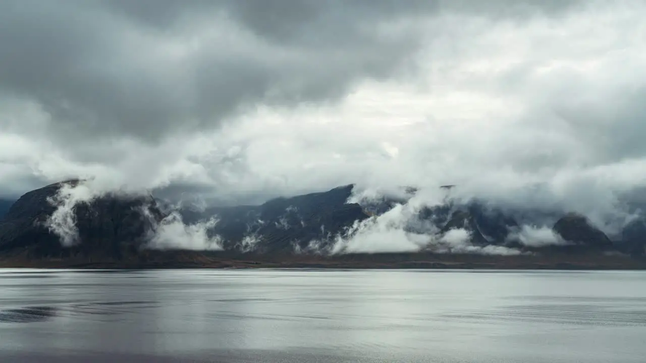 Majestic Mountain By The Lake Surrounded By Dramatic Clouds In Iceland On A Moody Weather timelapse