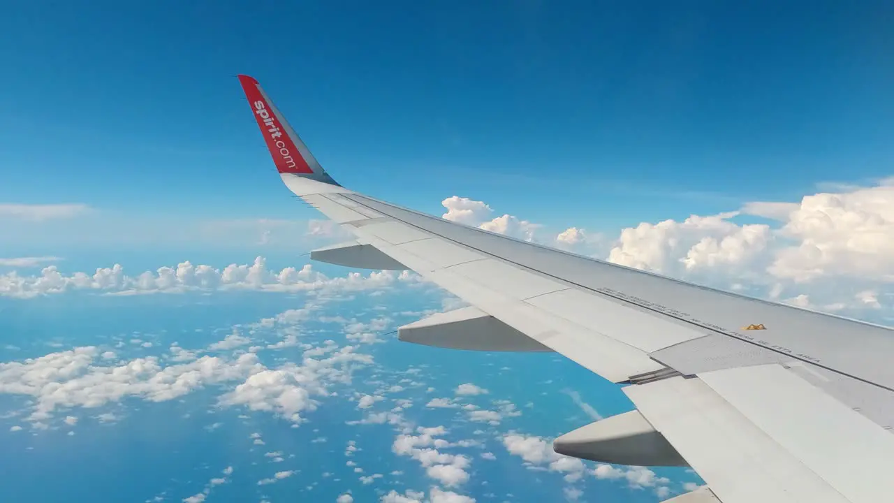 Shot of wing of an airplane flying through white clouds on a cloudy day in Mexico city Mexico