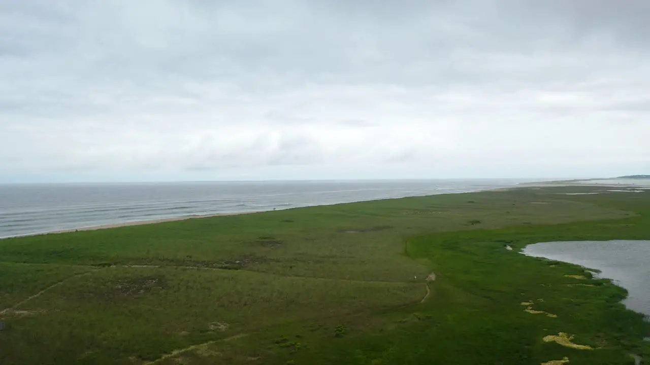 Aerial Drone Shot of Ocean and Marsh on Dark Cloudy Day in Cape Cod Massachusetts Pan Right