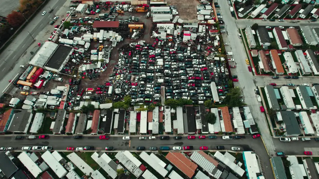 Top view of an Auto Wreck Yard full of Cars Cloudy Day