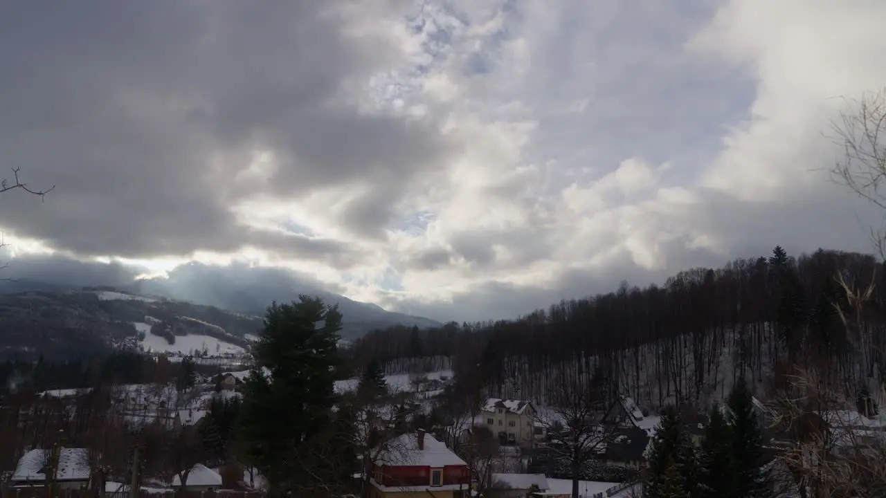 Clouds roll in over a picturesque mountain town in the valley of the Jesenik region