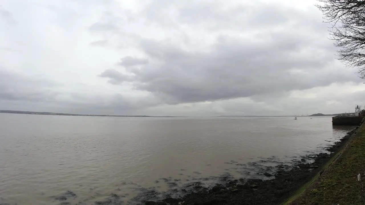 British overcast waterfront promenade gloomy clouds fast over rippling tide