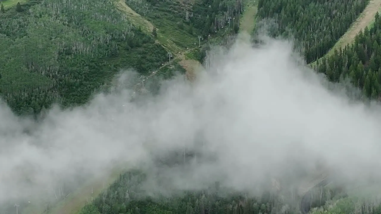 Aerial of low fog hanging over mountain and forest trees-7