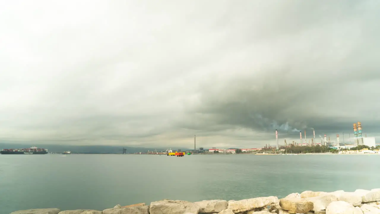 Industrial vessel and smoking factory near Gibraltar port time lapse view