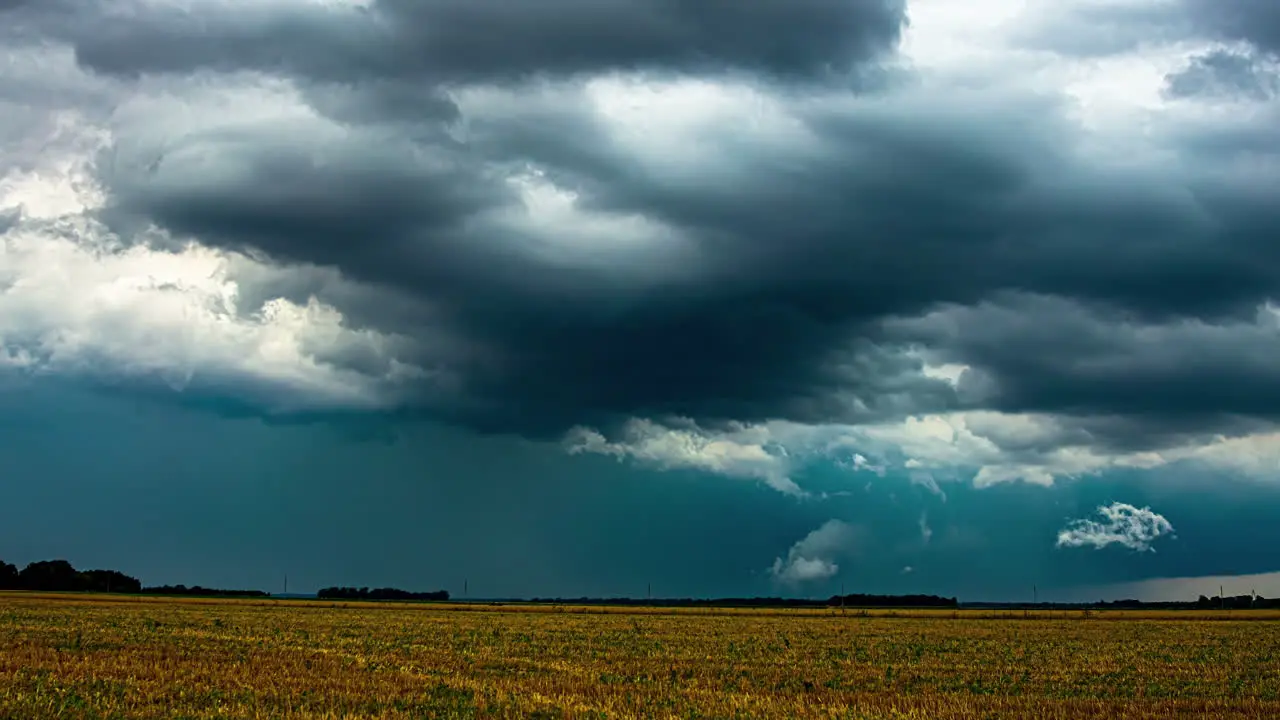 Timelapse of Spectacular Clouds Above Farmland with Tractors Harvesting in Action