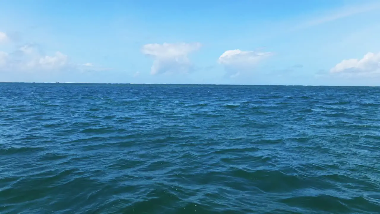 view of a choppy ocean under a blue sky